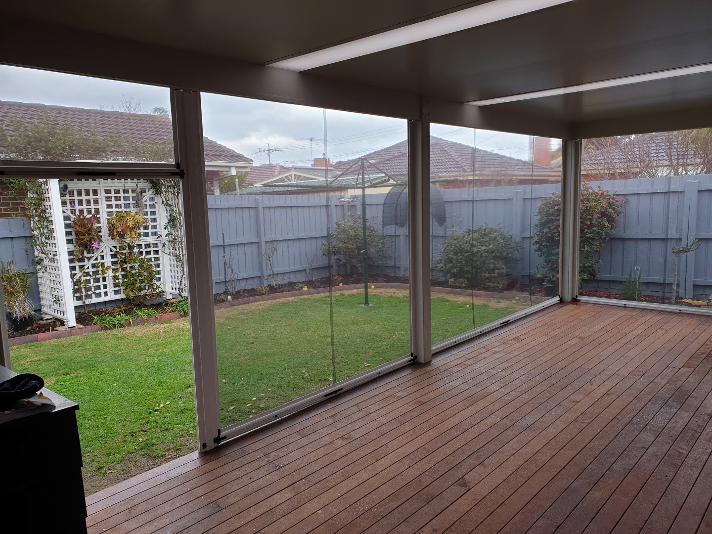 Ziptrak blinds fitted around a covered outdoor pergola.